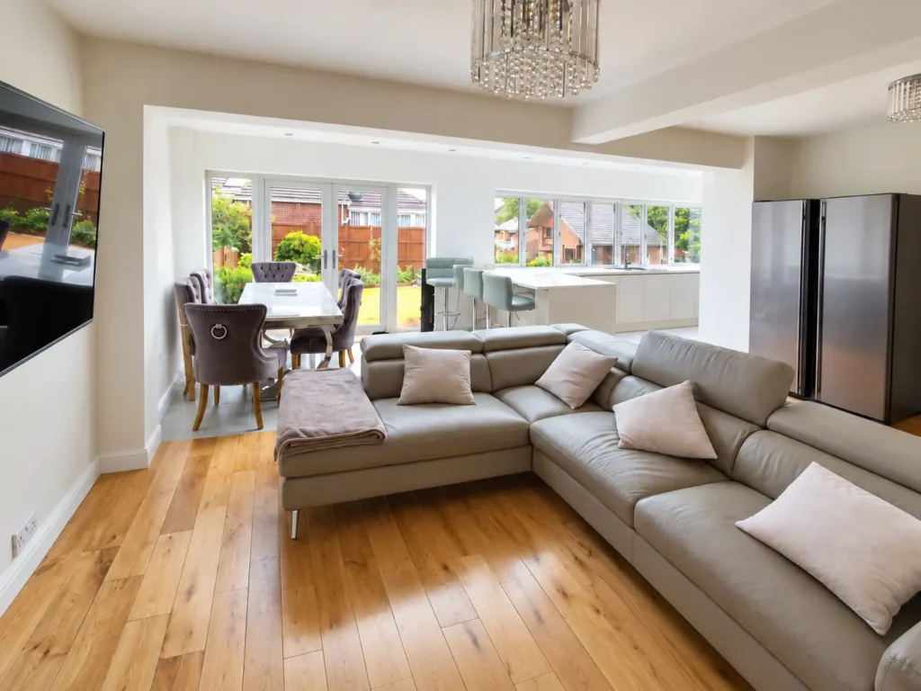 Open-plan living and dining area in a South Oxford rear extension, featuring a contemporary kitchen, garden-facing glazing and timber flooring.